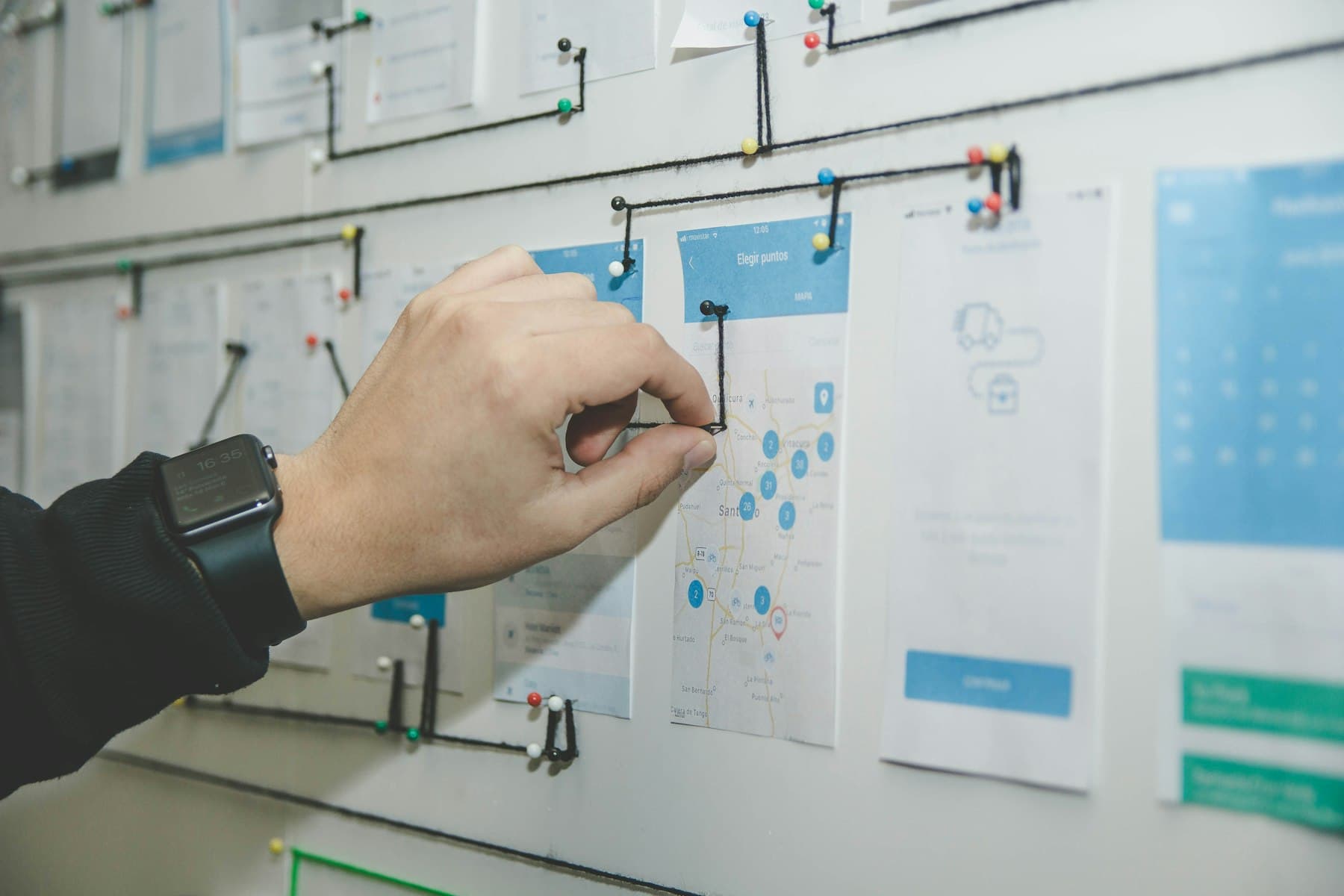 Website wireframes pinned up while an agency site is designed.